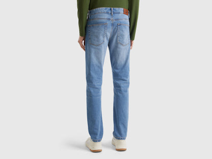 Flat lay front view of blue five-pocket jeans for men.