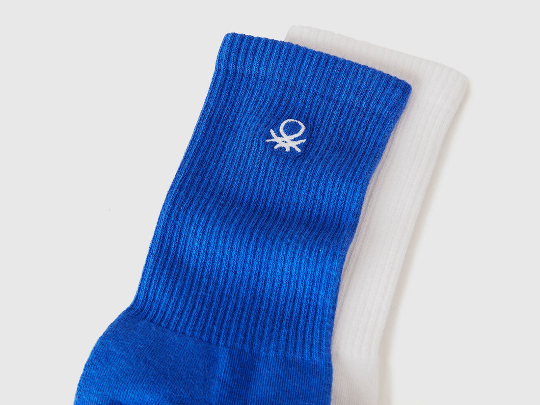 Close-up of a blue athletic sock for men or boys, showing a white logo.