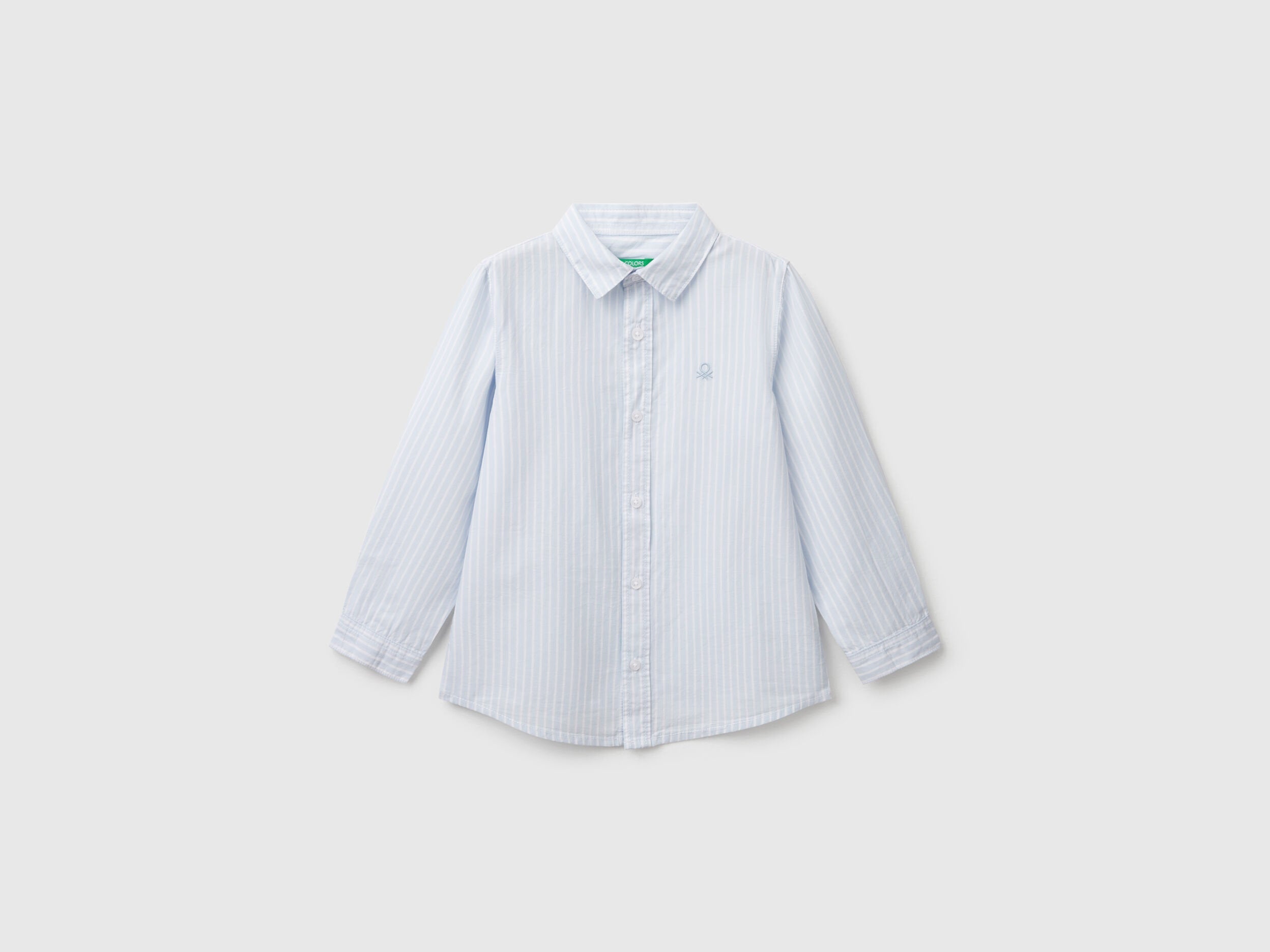 Front view of a white and blue striped shirt for men or boys in Kuwait.