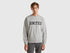 Front view of a man wearing a light grey crew neck sweatshirt.