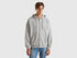 Front view of a man wearing a plain grey zip-up hoodie.