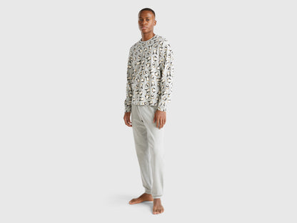 Full-length front view of a man wearing white pyjamas with a penguin print in Kuwait.