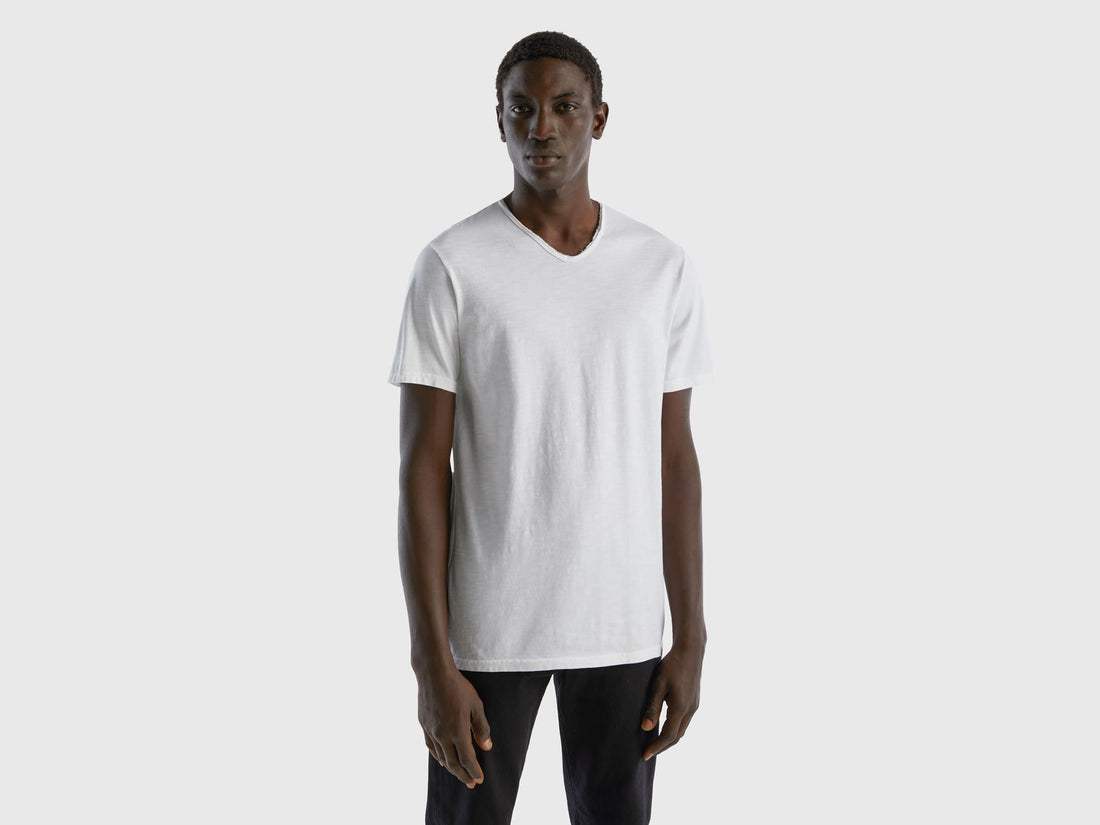 Front view of a man wearing a white V-neck t-shirt.