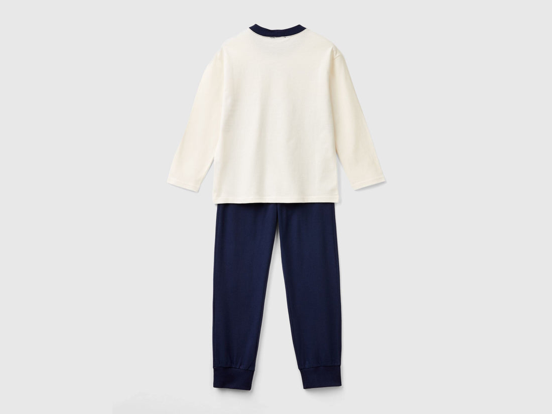 Back view of a simple, long-sleeve, white cotton top and plain navy blue bottoms, forming a basic yet comfortable set of pyjamas Kuwait for men&