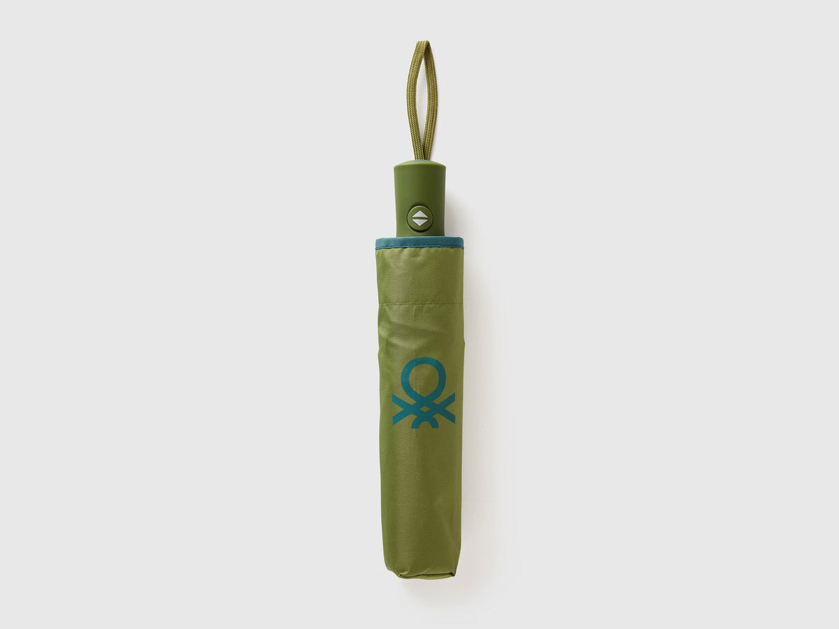 Folded military green Benetton umbrella, compact travel size.