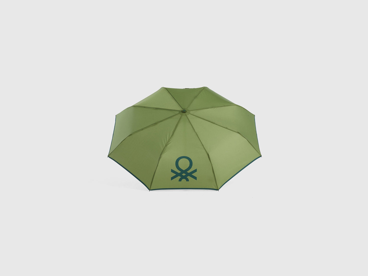 Open military green Benetton umbrella, top view for rain.