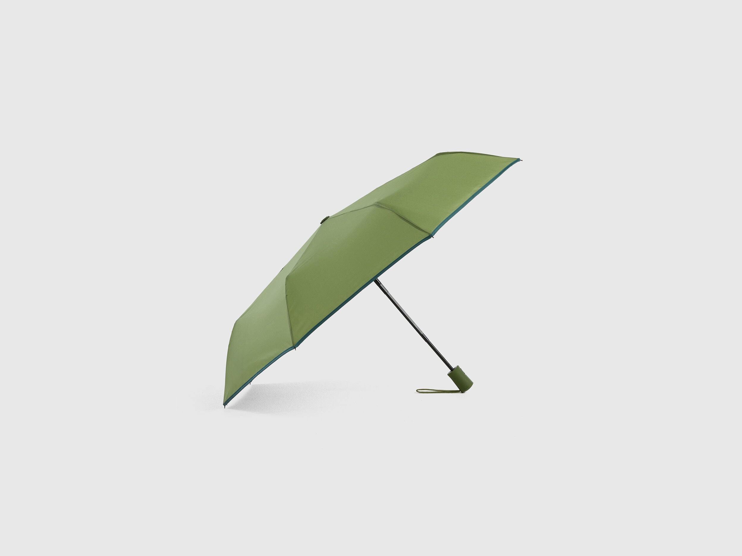 Military green Benetton umbrella, partially open, durable.