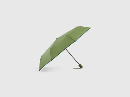 Military green Benetton umbrella, partially open, durable.