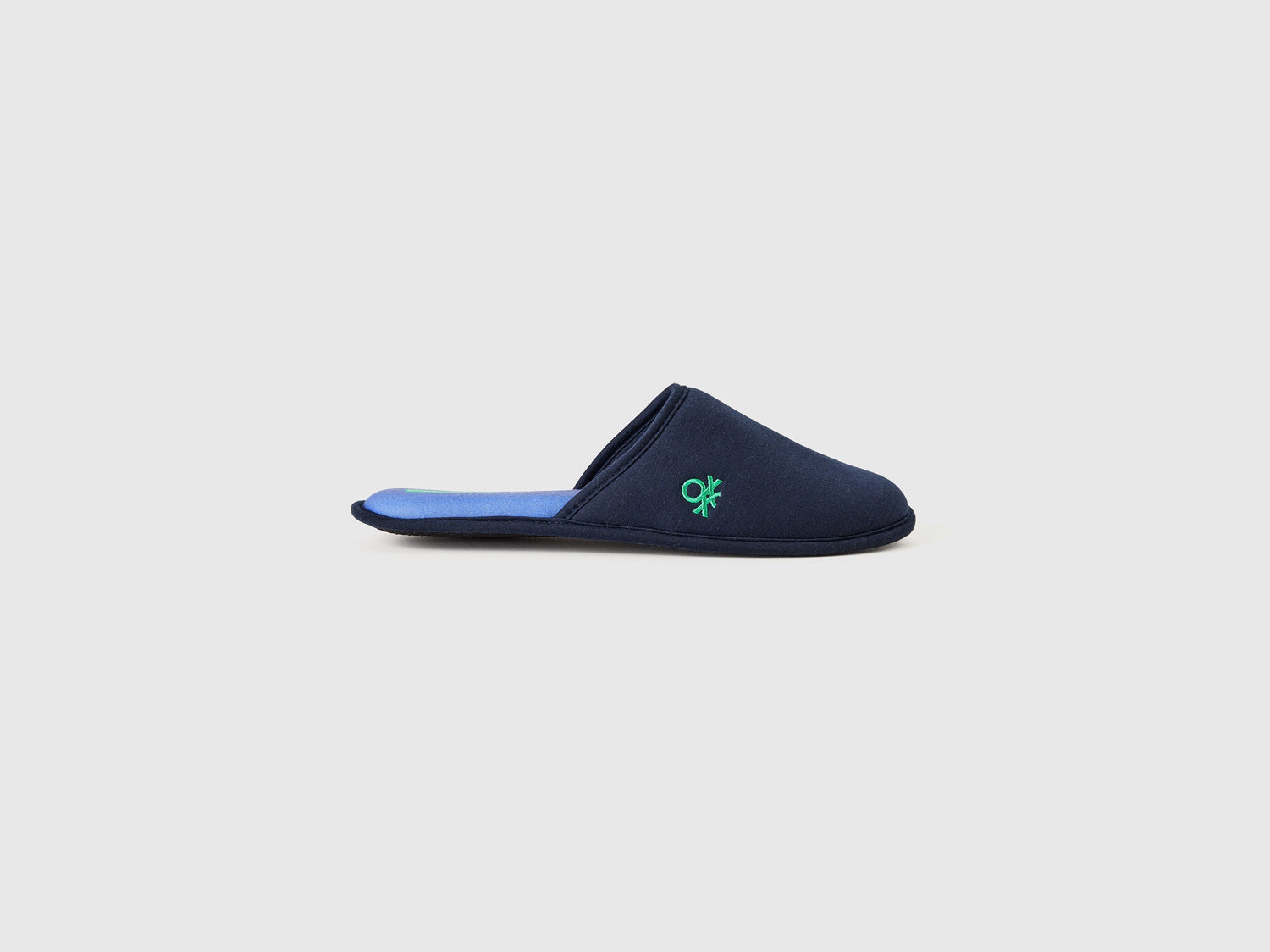 Single navy blue slipper with a green logo on the side.