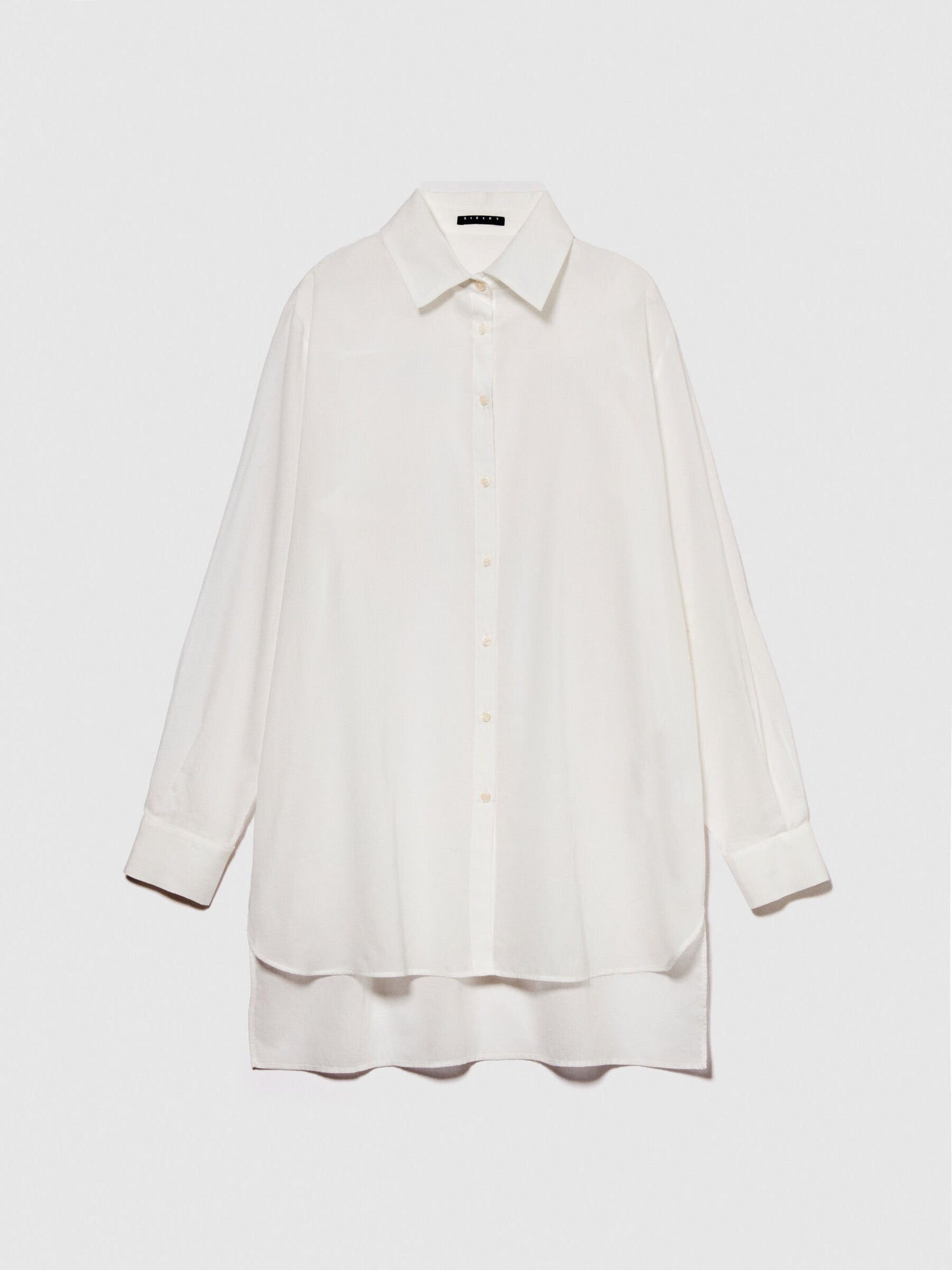 Flat lay of a folded oversized white long-sleeve shirt.