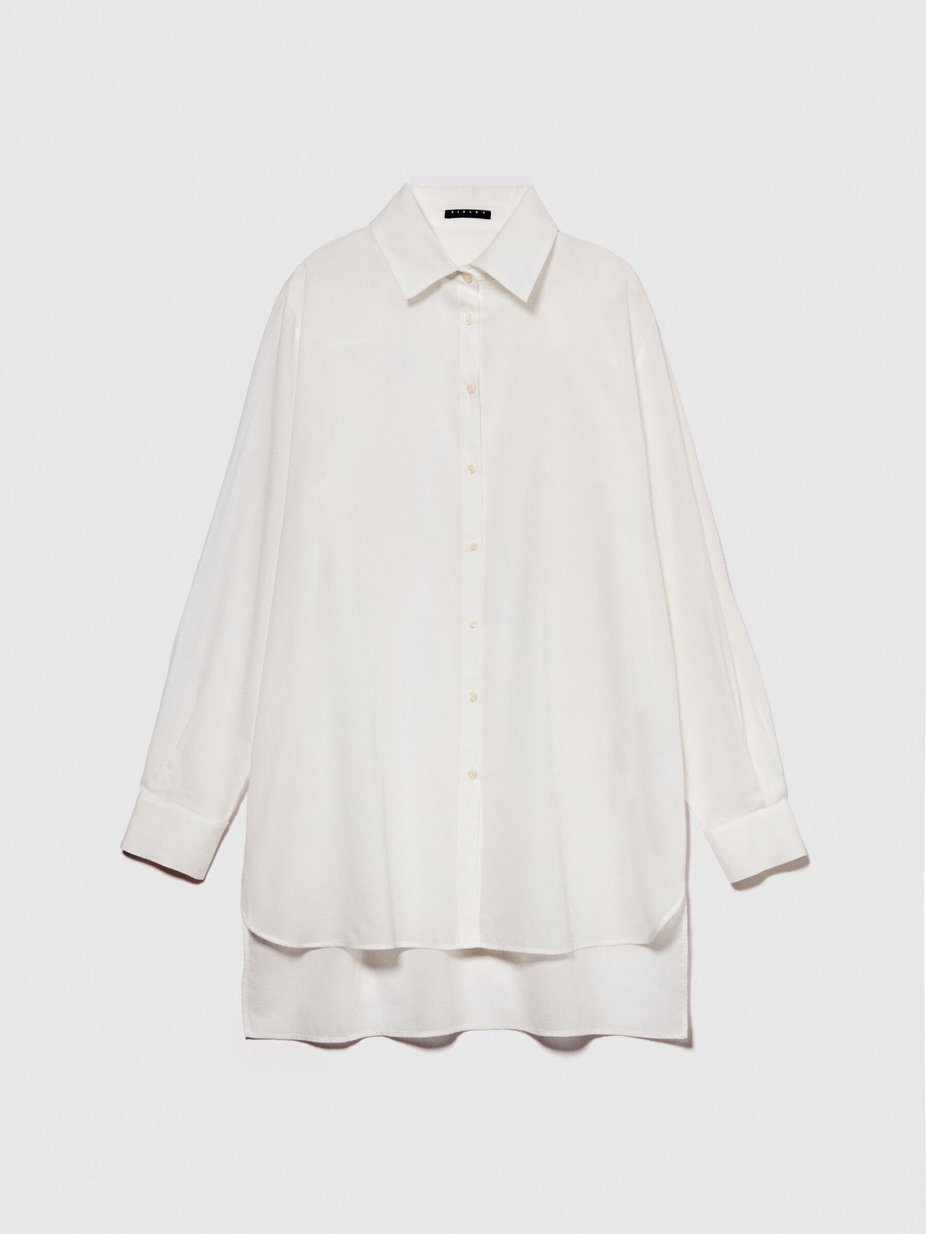 Flat lay of a folded oversized white long-sleeve shirt.