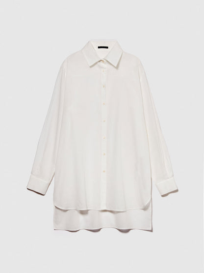 Flat lay of a folded oversized white long-sleeve shirt.