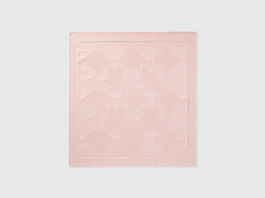 Front view of a light pink Benetton knit baby blanket with subtle texture. Soft and warm.