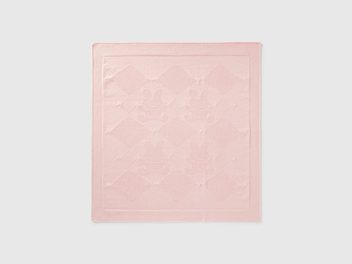 Front view of a light pink Benetton knit baby blanket with subtle texture. Soft and warm.