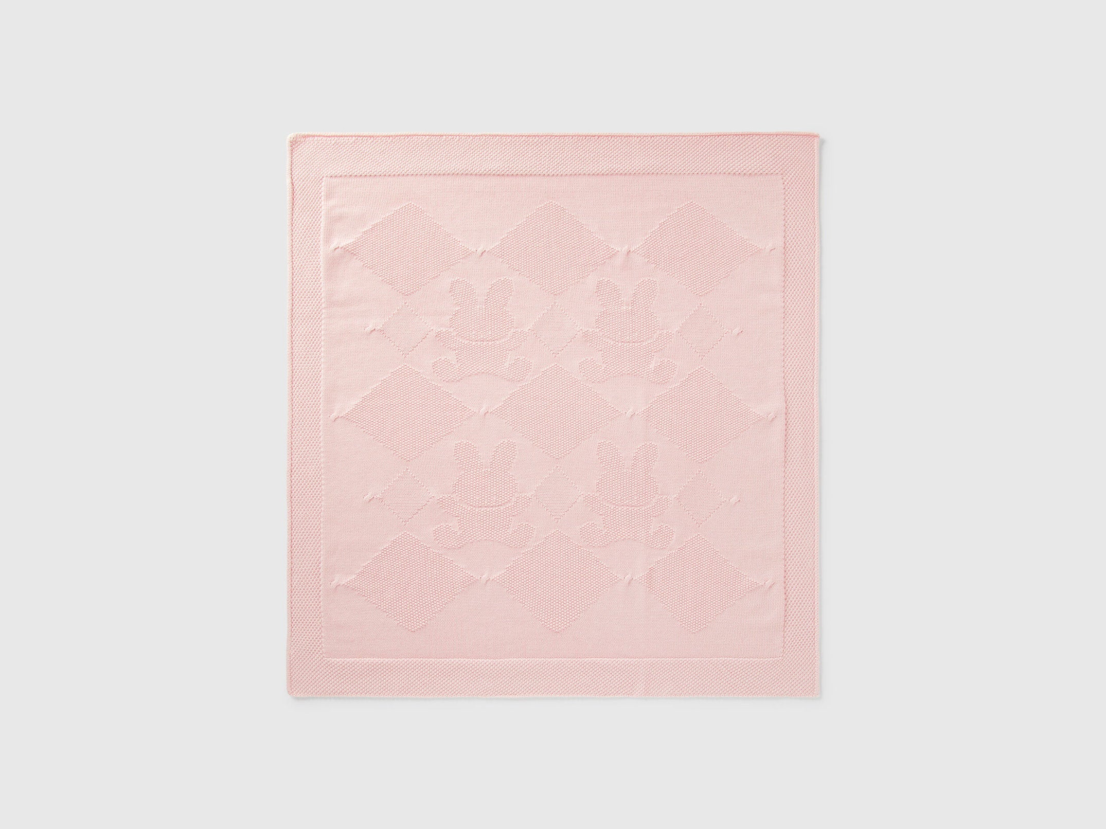 Front view of a light pink Benetton knit baby blanket with subtle texture. Soft and warm.