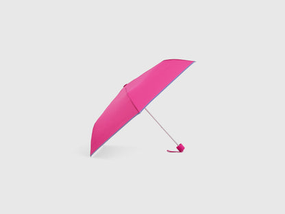 Pink Benetton umbrella, partially open, stylish rain gear.