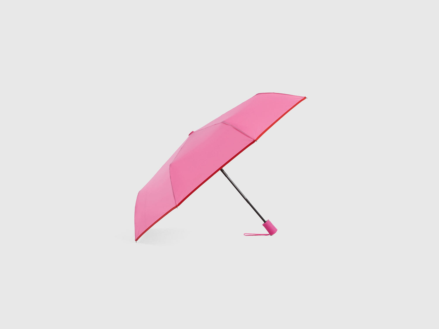Pink Benetton umbrella, partially open, stylish rain gear.