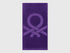 A folded purple beach towel, showing its vibrant color and plush texture.