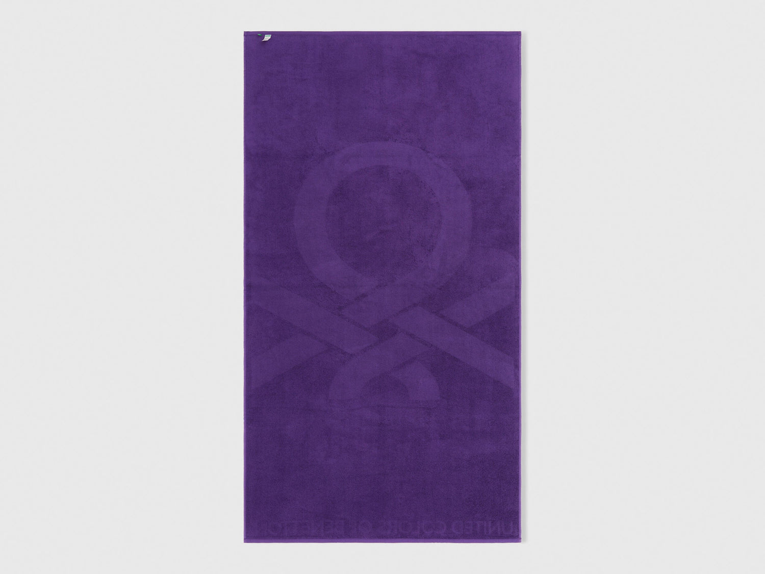 A single purple beach towel on a plain background, highlighting its full size and design.