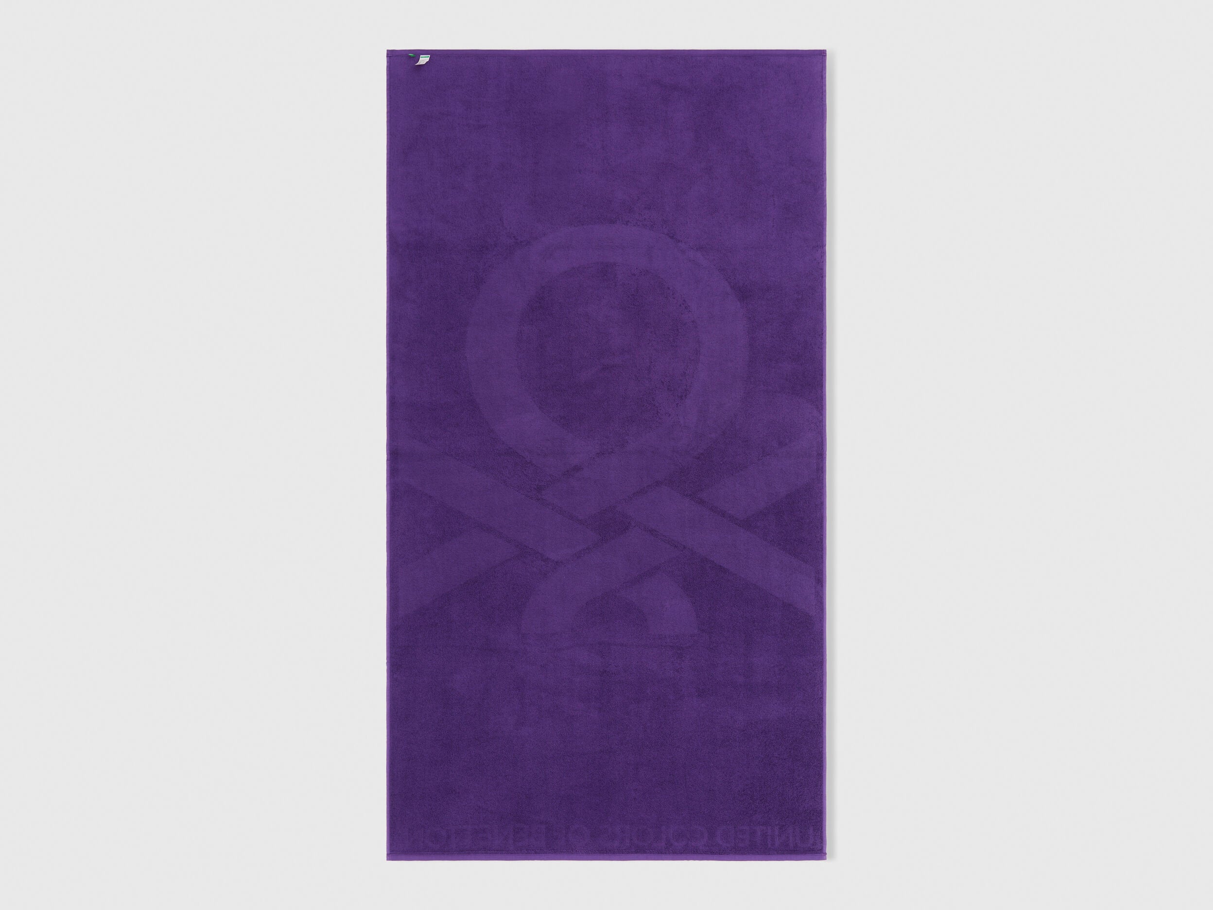 A single purple beach towel on a plain background, highlighting its full size and design.
