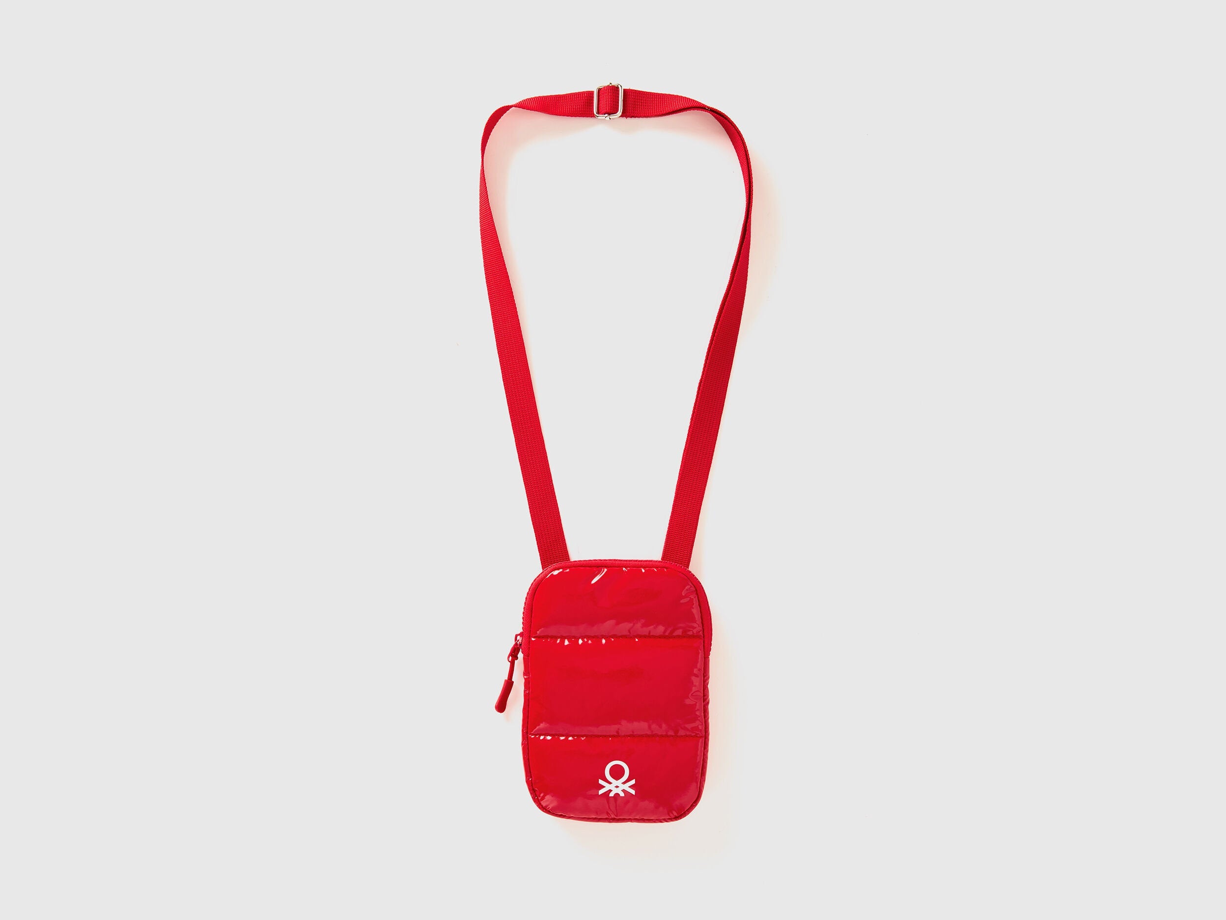 Front view of a red cell phone case with a long shoulder strap and Benetton logo.
