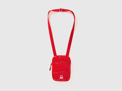 Front view of a red cell phone case with a long shoulder strap and Benetton logo.