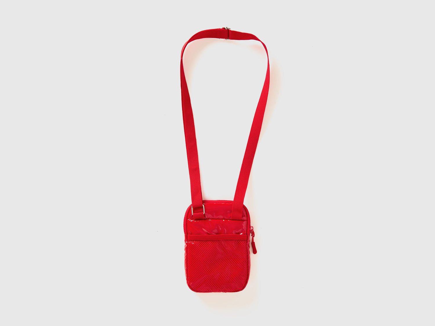 Side view of a red cell phone case with a shoulder strap and quilted texture. Compact.