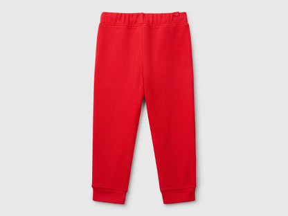 Back view of plain red sweet pants.