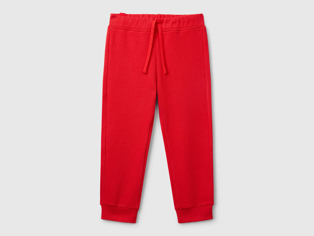 Front view of red sweet pants with a drawstring waistband.