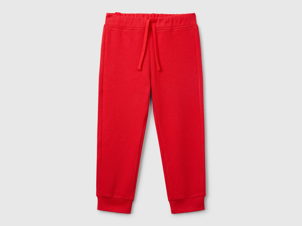 Front view of red sweet pants with a drawstring waistband.