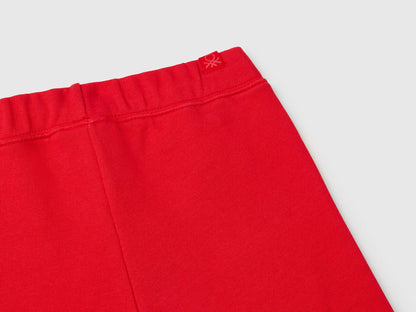 Close-up of the elastic waistband and fabric detail on red sweet pants