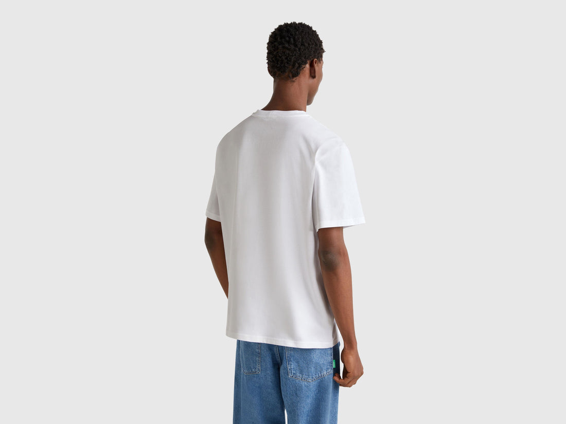 Back view of white Benetton oversized t-shirt. Simple, plain design for comfort.