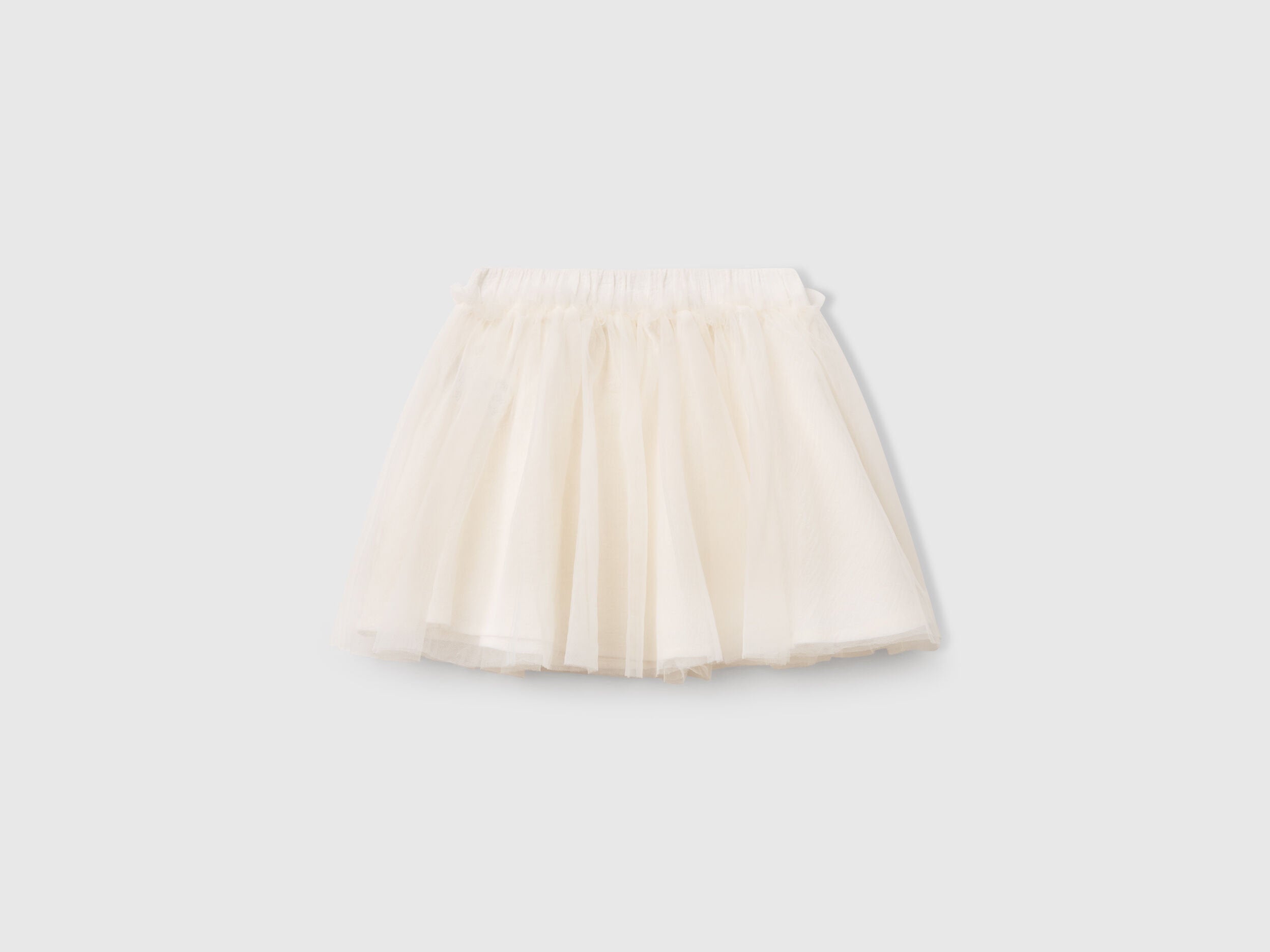 Front view of a white Benetton tulle skirt, featuring a full, ruffled silhouette. Lightweight and airy.