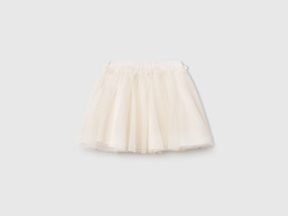 Front view of a white Benetton tulle skirt, featuring a full, ruffled silhouette. Lightweight and airy.