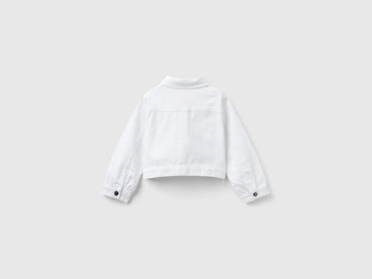 Back view of a white cropped jacket, showcasing its clean lines and fitted design.
