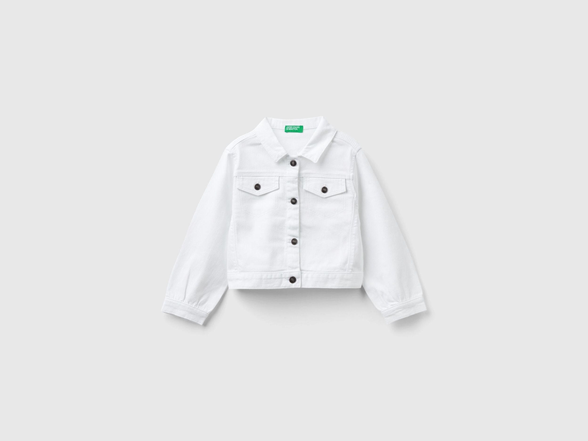 Front view of a white cropped jacket in stretch cotton denim, featuring silver buttons and a classic collar.
