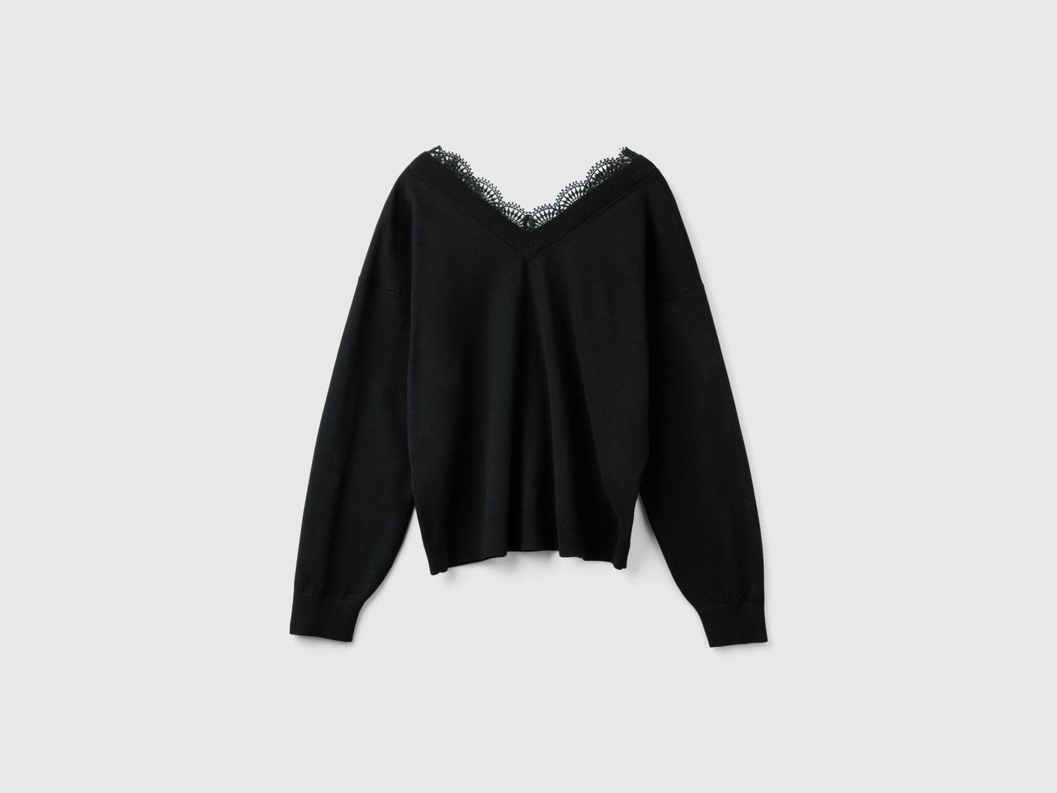 Flat lay back view of a black flowy top for women with lace detail.