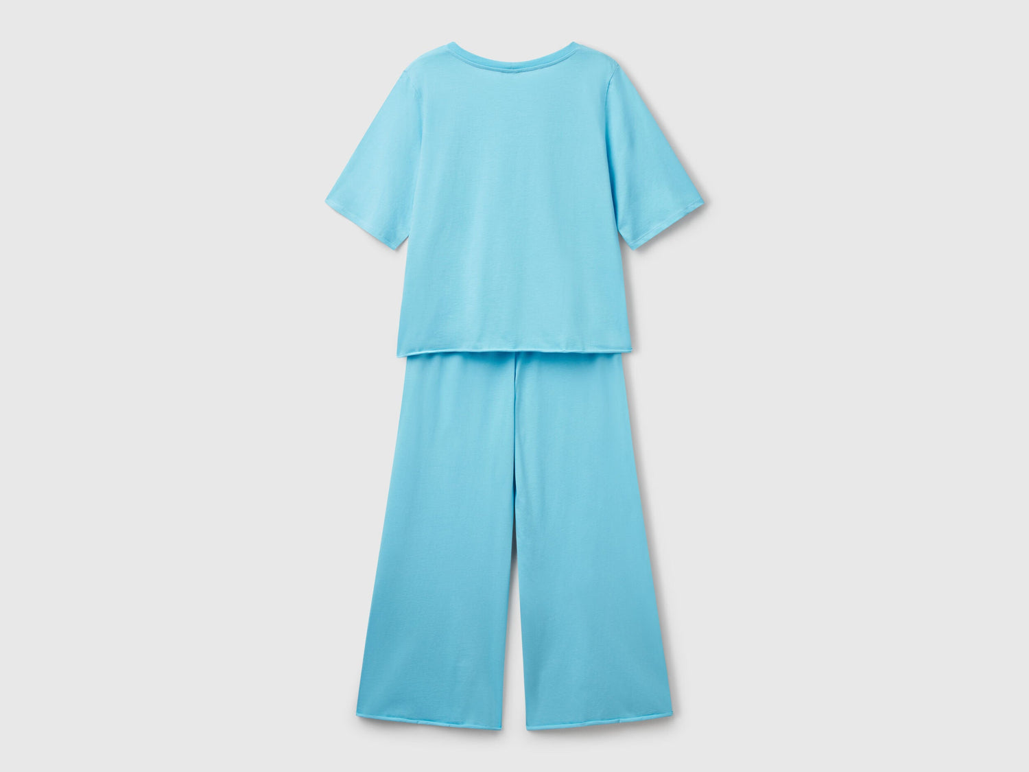 Flat lay back view of a light blue loose-fitting pyjama set for women.