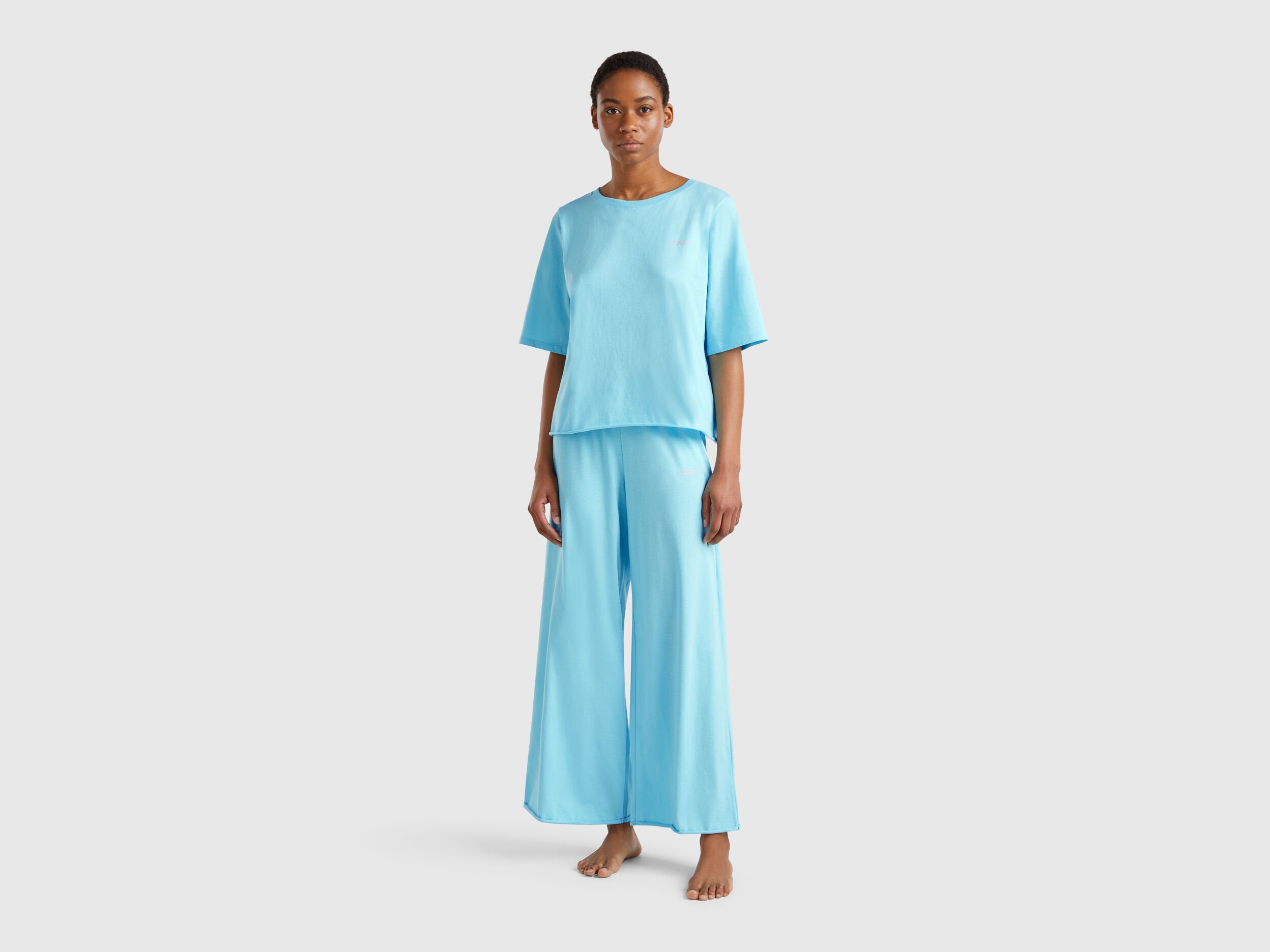 Front view of a woman wearing a light blue loose-fitting pyjama set.