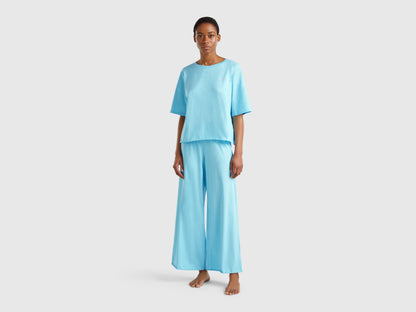 Front view of a woman wearing a light blue loose-fitting pyjama set.