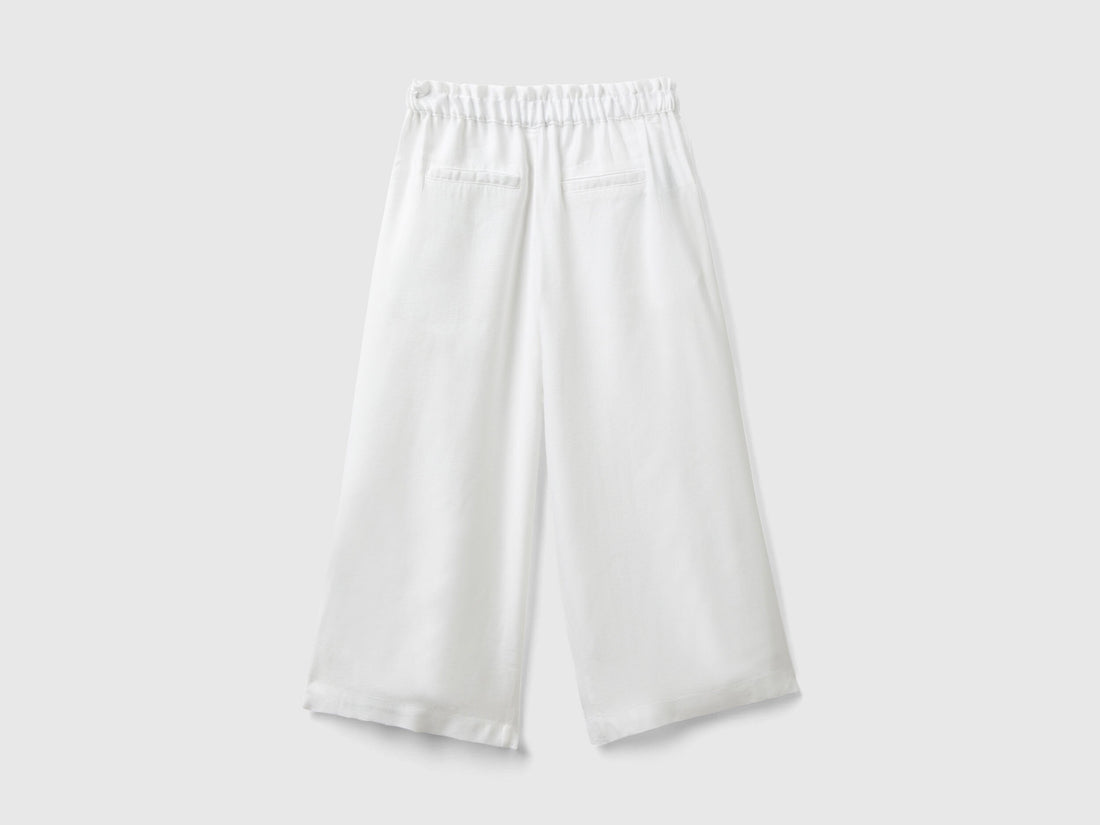 Close-up of the fabric and wide leg silhouette of palazzo pants.