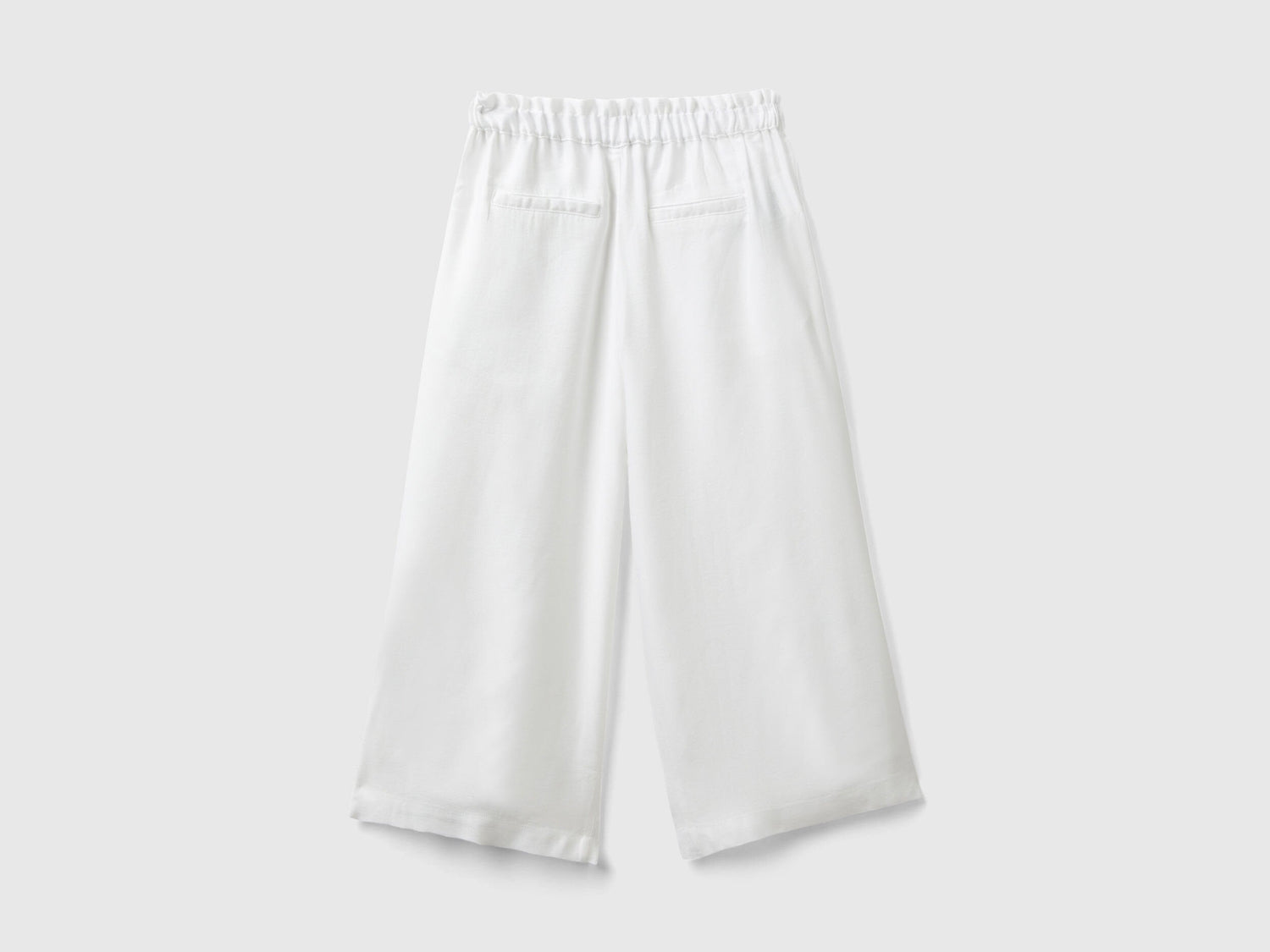 Close-up of the fabric and wide leg silhouette of palazzo pants.