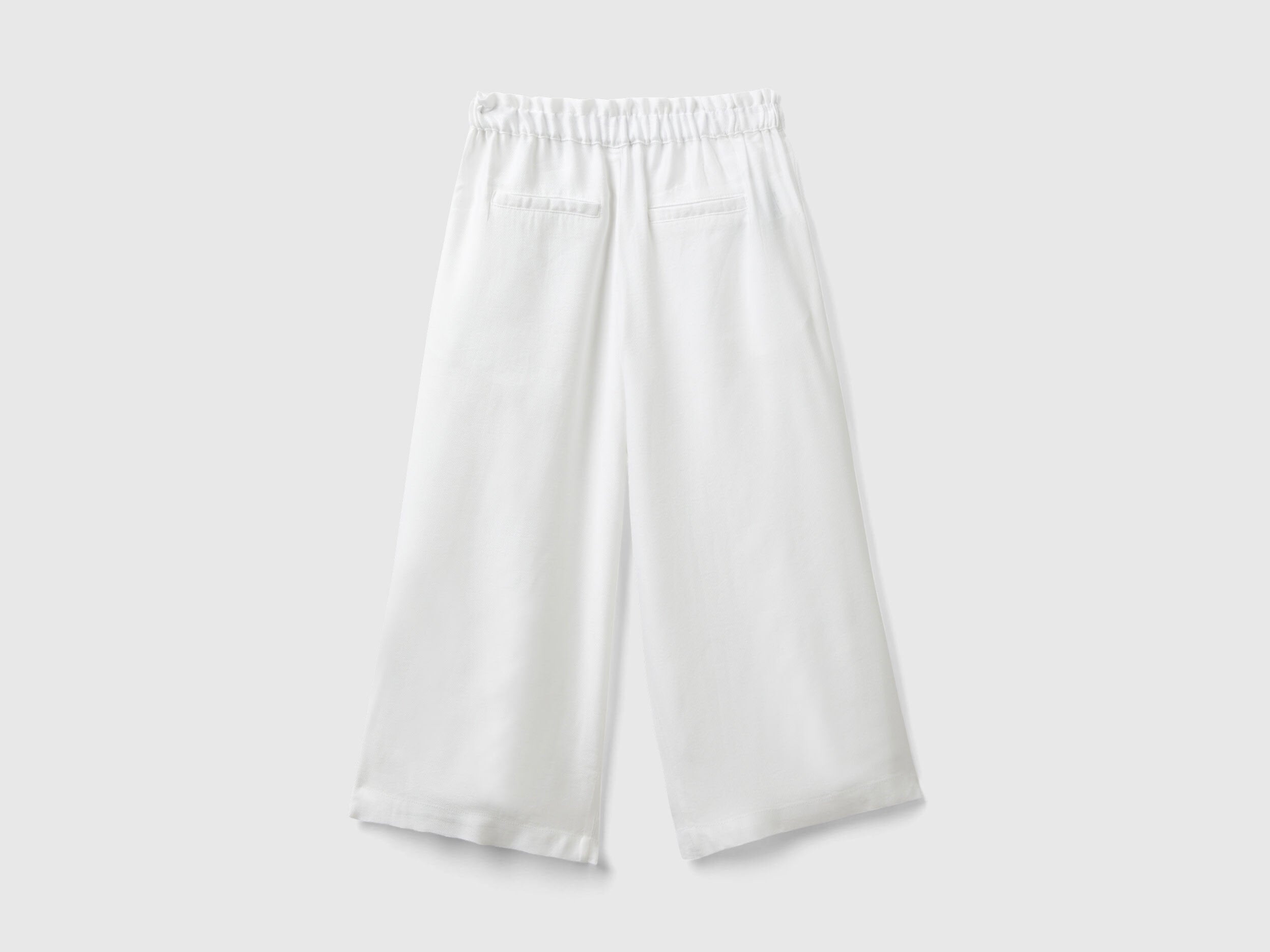 Close-up of the fabric and wide leg silhouette of palazzo pants.