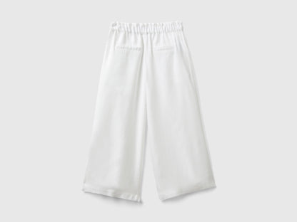 Close-up of the fabric and wide leg silhouette of palazzo pants.