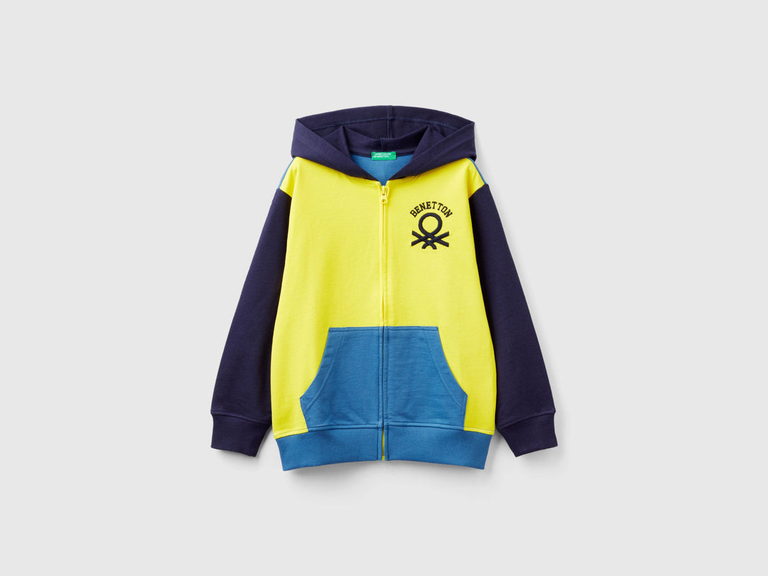 Front view of a yellow, dark blue, and light blue zip-up hoodie with a logo.