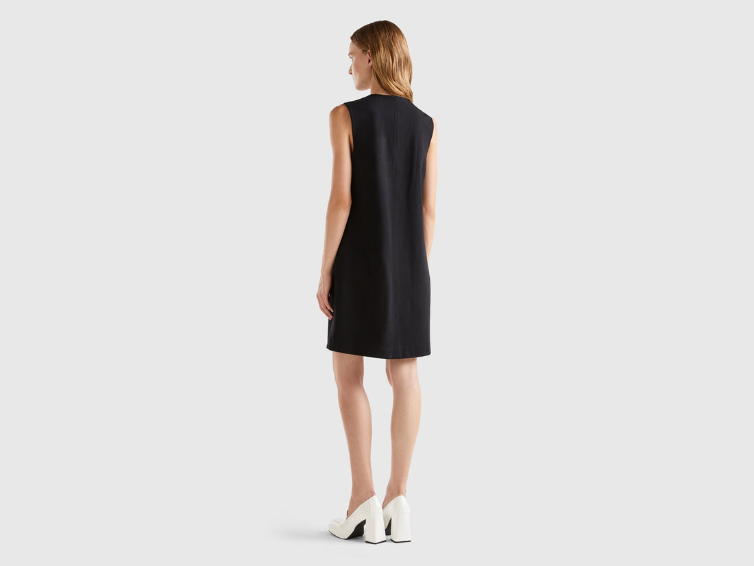 Back view of a female model wearing a stylish wrap dress.
