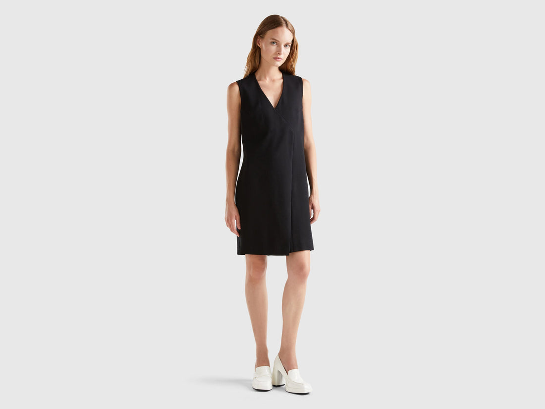 Front view of a female model wearing an elegant wrap dress.