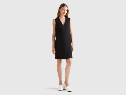 Front view of a female model wearing an elegant wrap dress.