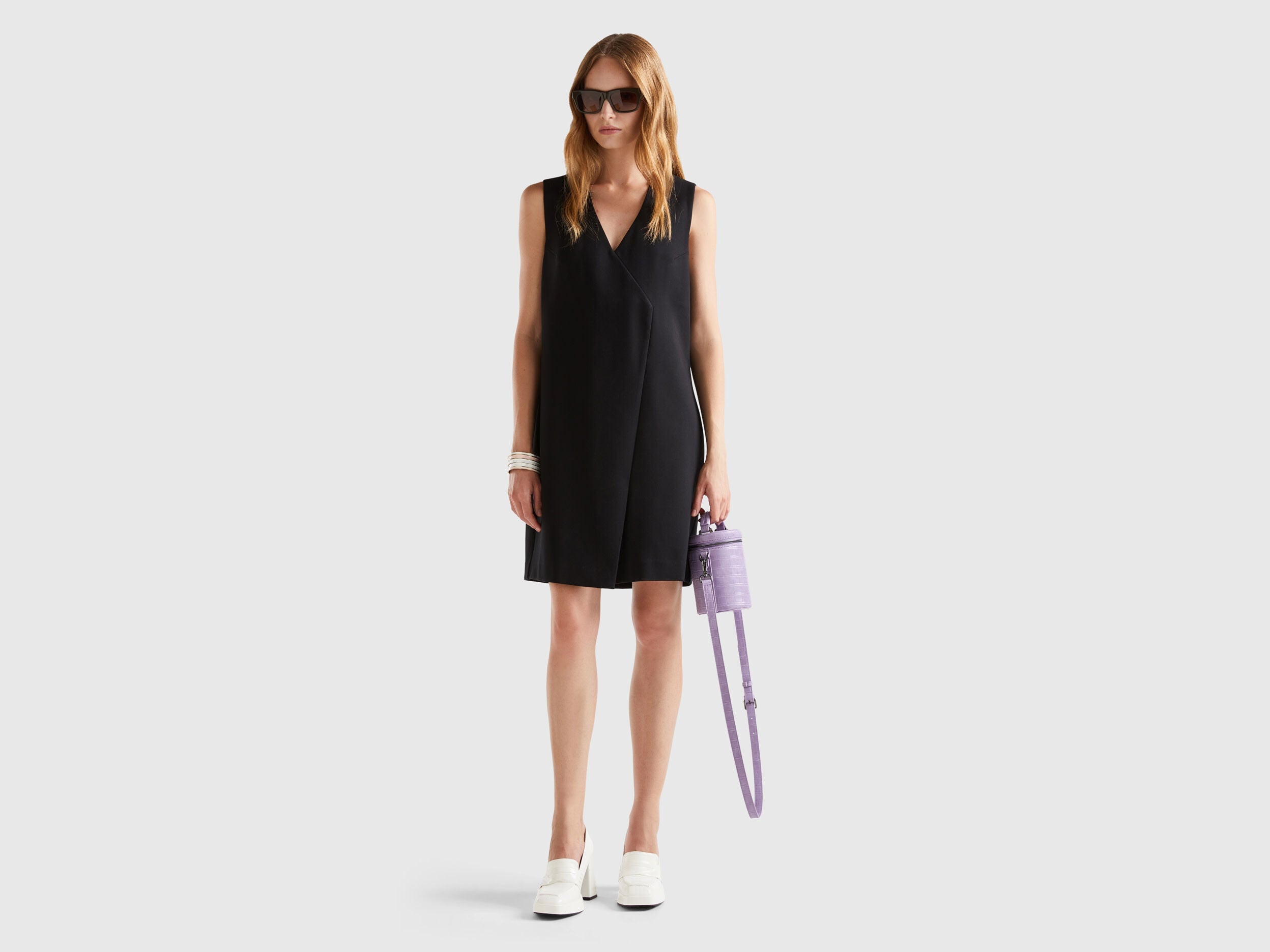 Side profile of a female model showcasing the silhouette of a wrap dress.