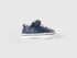 A single first-step kids shoe with a white sole and velcro strap, designed for comfort and early walkers in Kuwait.